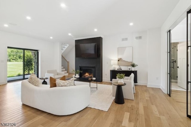 121 Culberson Rd, Bernards Twp, NJ 07920 - living room with recessed lighting, light wood-style flooring, a large fireplace, stairway, and baseboards