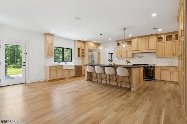 121 Culberson Rd, Bernards Twp, NJ 07920 - kitchen featuring premium appliances, light wood-style floors, a sink, a kitchen bar, and recessed lighting