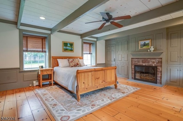 22 Hilltop Cir, Mendham Twp, NJ 07945 - bedroom featuring beamed ceiling, wainscoting, a glass covered fireplace, and light wood-type flooring