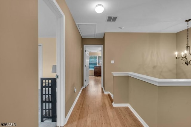 70 River Birch Cir, Montgomery Twp, NJ 08540 - hallway featuring attic access, wood finished floors, a chandelier, and an upstairs landing