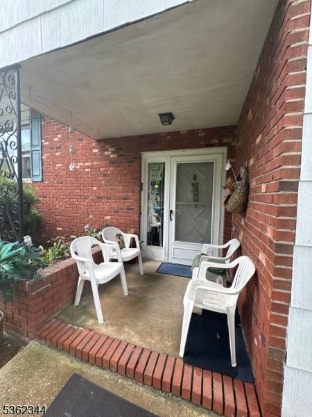 61 N Hillside Ave, Roxbury Twp, NJ 07847 - property entrance featuring brick siding and a porch
