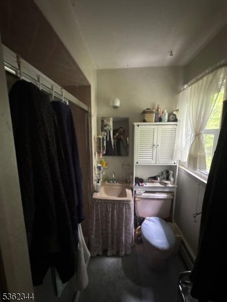 61 N Hillside Ave, Roxbury Twp, NJ 07847 - bathroom with a sink, curtained shower, toilet, a bath, and a baseboard heating unit