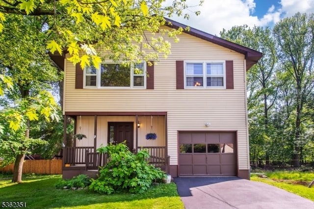 40 Riveredge Dr, Fairfield Twp, NJ 07004 - view of front facade with an attached garage, asphalt driveway, board and batten siding, and a porch