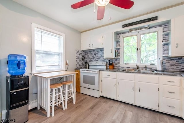 26 Park Ave, Hanover Twp, NJ 07960 - kitchen with white electric range, a sink, a ceiling fan, backsplash, and white cabinetry