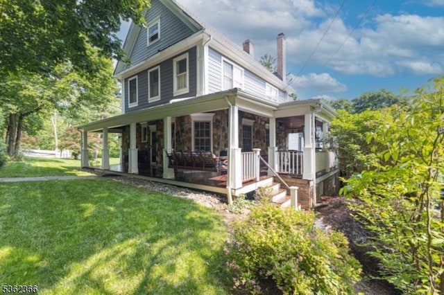 1417 Long Hill Rd, Long Hill Twp, NJ 07946 - view of side of property featuring a lawn, a chimney, covered porch, and stone siding