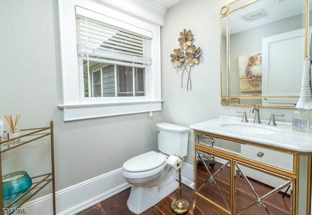 1417 Long Hill Rd, Long Hill Twp, NJ 07946 - bathroom featuring toilet, vanity, baseboards, and wood finished floors