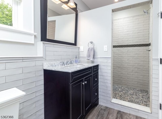 1417 Long Hill Rd, Long Hill Twp, NJ 07946 - full bath with tile walls, a tile shower, vanity, toilet, and wood finished floors