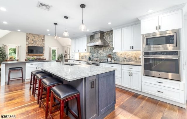 1417 Long Hill Rd, Long Hill Twp, NJ 07946 - kitchen with appliances with stainless steel finishes, wall chimney exhaust hood, a sink, dark wood-style floors, and backsplash