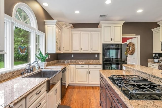 16 Olde York Rd, Randolph Twp, NJ 07869 - kitchen with black appliances, light stone countertops, recessed lighting, and light wood finished floors