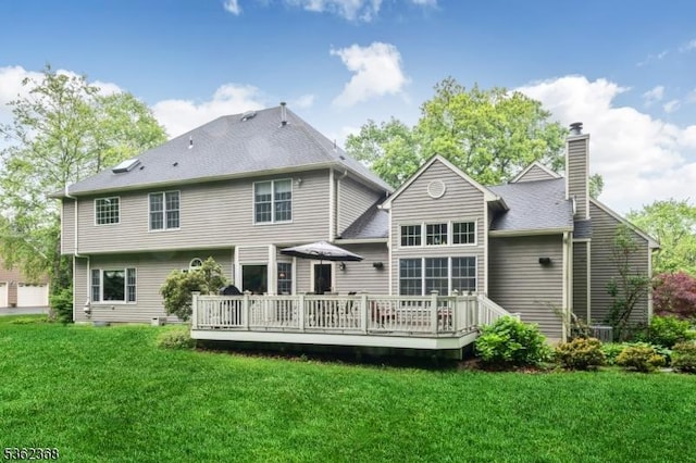 16 Olde York Rd, Randolph Twp, NJ 07869 - back of house with a chimney, a deck, and a lawn