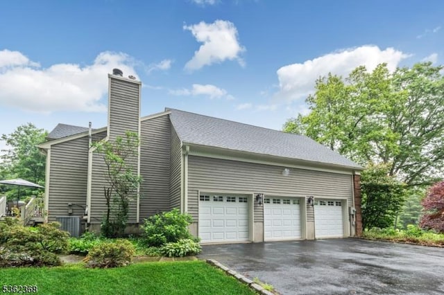 16 Olde York Rd, Randolph Twp, NJ 07869 - view of side of property featuring driveway, a garage, and a chimney