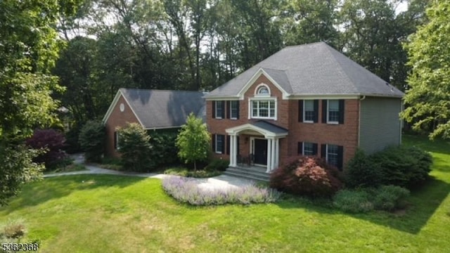 16 Olde York Rd, Randolph Twp, NJ 07869 - colonial-style house featuring a front yard and view of scattered trees