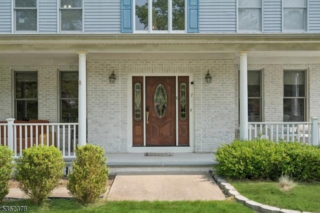 7 Cranberry Ct, North Haledon Boro, NJ 07508 - doorway to property featuring covered porch and brick siding