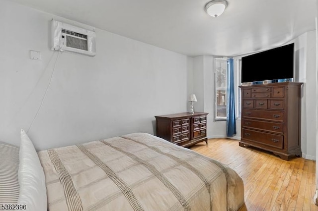 23 Foundry St, Newark City, NJ 07105 - bedroom featuring a wall unit AC, light wood-style floors, and baseboards