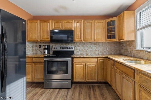 23 Foundry St, Newark City, NJ 07105 - kitchen featuring black appliances, a sink, dark wood finished floors, light stone counters, and glass insert cabinets