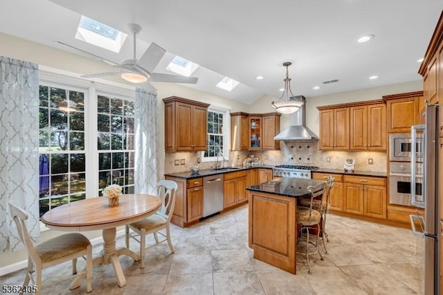 61 Bradley Ln, Bridgewater Twp, NJ 08807 - kitchen with wall chimney range hood, a skylight, stainless steel appliances, brown cabinets, and lofted ceiling