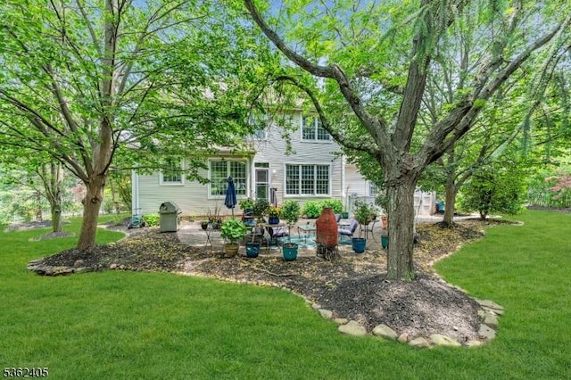 61 Bradley Ln, Bridgewater Twp, NJ 08807 - rear view of house with a lawn and a patio area