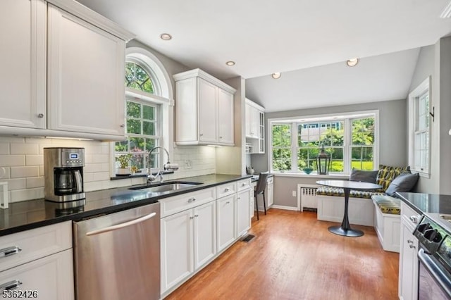 534 Summit Ave, Maplewood Twp, NJ 07040 - kitchen with appliances with stainless steel finishes, a sink, healthy amount of natural light, dark countertops, and lofted ceiling