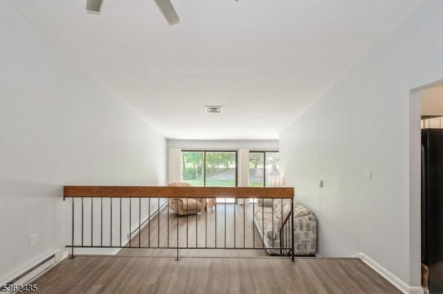 1 N Slope Unit 1, Union Twp, NJ 08809 - stairway with a baseboard heating unit, wood finished floors, and baseboards