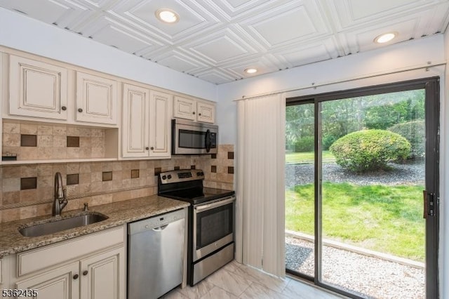 1 N Slope Unit 1, Union Twp, NJ 08809 - kitchen with appliances with stainless steel finishes, a sink, cream cabinetry, light marble finish flooring, and backsplash