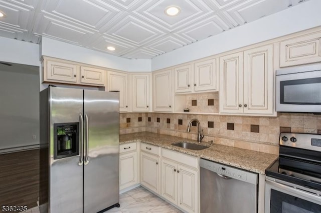 1 N Slope Unit 1, Union Twp, NJ 08809 - kitchen with stainless steel appliances, cream cabinetry, a sink, an ornate ceiling, and decorative backsplash