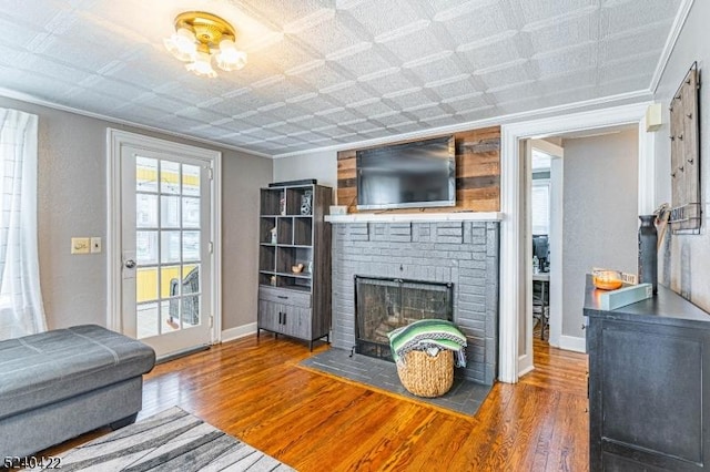315 Green St, Boonton Town, NJ 07005 - living room featuring wood finished floors, a brick fireplace, and crown molding