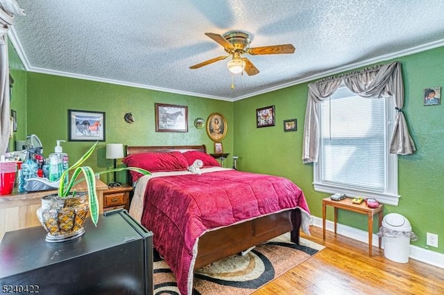 315 Green St, Boonton Town, NJ 07005 - bedroom with crown molding, wood finished floors, a textured ceiling, and ceiling fan