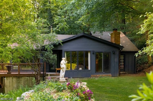 122 Buffalo Hollow Rd, Lebanon Twp, NJ 08826 - rear view of property with a deck, a chimney, a yard, and board and batten siding