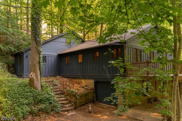 122 Buffalo Hollow Rd, Lebanon Twp, NJ 08826 - rear view of house featuring board and batten siding, stairway, and a garage