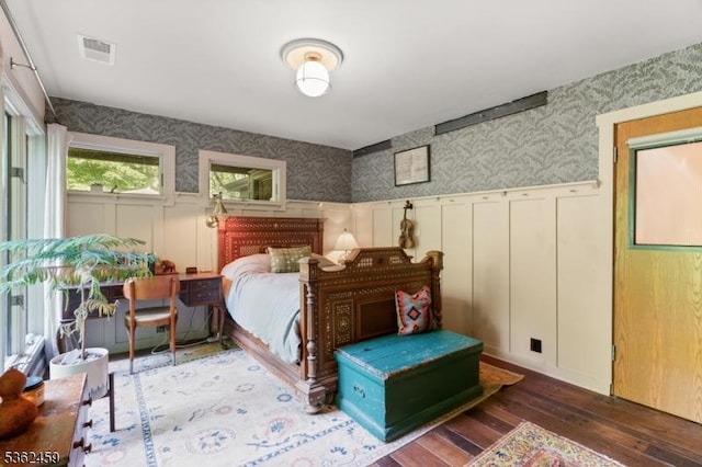 122 Buffalo Hollow Rd, Lebanon Twp, NJ 08826 - bedroom featuring wallpapered walls, wood-type flooring, a wainscoted wall, and a decorative wall