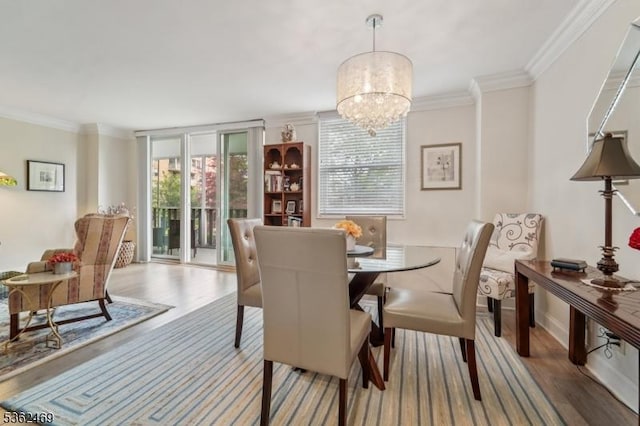 530 Valley Rd Unit 2D, Montclair Twp, NJ 07043 - dining space featuring wood finished floors, a chandelier, and ornamental molding