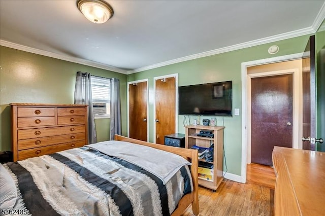 2145 Keller Crk, Union Twp, NJ 07083 - bedroom with light wood-type flooring, crown molding, baseboards, and multiple closets