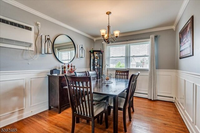 2145 Keller Crk, Union Twp, NJ 07083 - dining area with a wall unit AC, a chandelier, a decorative wall, crown molding, and wainscoting