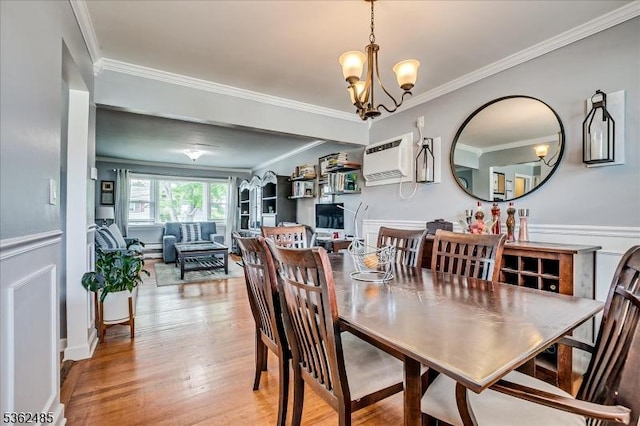 2145 Keller Crk, Union Twp, NJ 07083 - dining space featuring a chandelier, ornamental molding, light wood-type flooring, and an AC wall unit