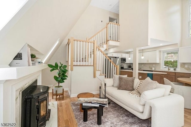 51 Scenic Dr, Green Twp, NJ 07821 - living room featuring light wood-type flooring, a towering ceiling, stairway, and baseboards