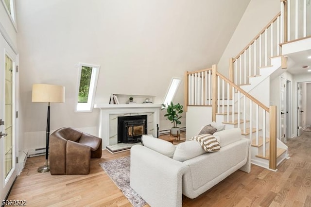 51 Scenic Dr, Green Twp, NJ 07821 - living room featuring a high ceiling, light wood-style floors, stairs, and a baseboard radiator