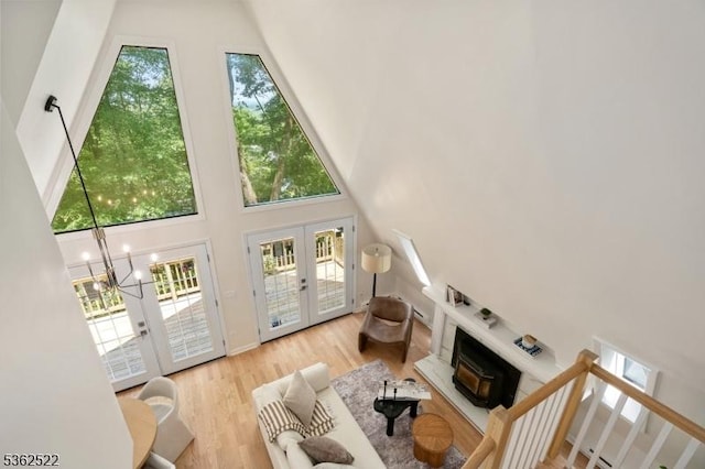 51 Scenic Dr, Green Twp, NJ 07821 - living area featuring a high ceiling, wood finished floors, a fireplace, french doors, and a chandelier
