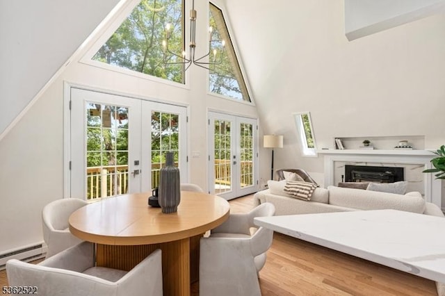 51 Scenic Dr, Green Twp, NJ 07821 - dining area with french doors, a towering ceiling, a baseboard radiator, wood finished floors, and a fireplace