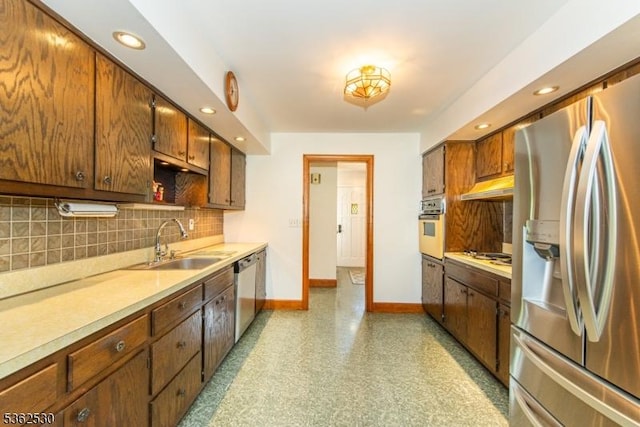 9 Ridge Rd, Roxbury Twp, NJ 07876 - kitchen with appliances with stainless steel finishes, a sink, baseboards, light countertops, and backsplash