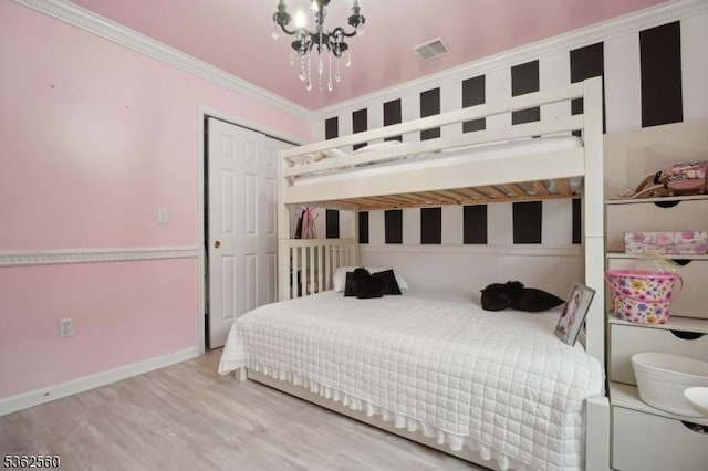 59 Guy St, Dover Town, NJ 07801 - bedroom with a chandelier, wood finished floors, ornamental molding, baseboards, and a closet