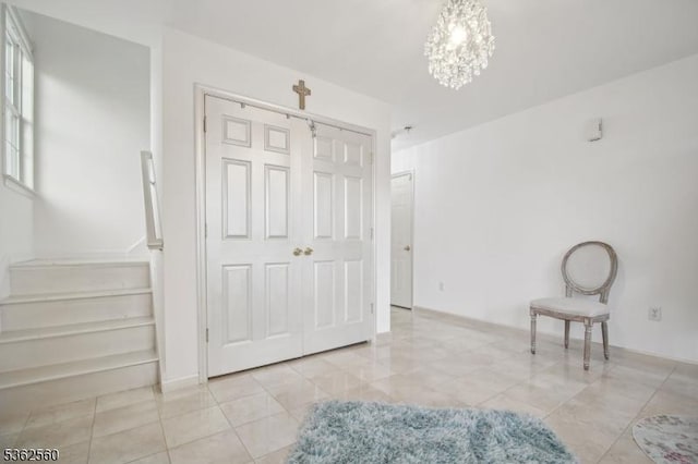 59 Guy St, Dover Town, NJ 07801 - unfurnished bedroom with a barn door, light tile patterned flooring, and a chandelier