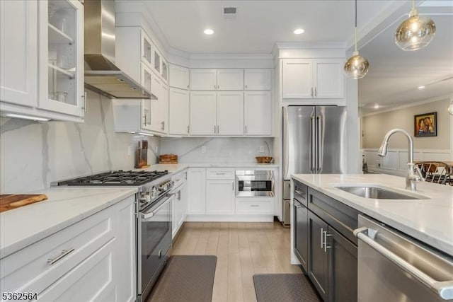 302 Tiffany Way Unit 302, Watchung Boro, NJ 07069 - kitchen with stainless steel appliances, wall chimney range hood, white cabinetry, decorative light fixtures, and ornamental molding