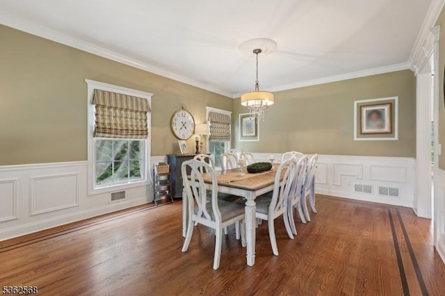 202 Old Sand Rd, Fairfield Twp, NJ 07004 - dining space with a chandelier, ornamental molding, wainscoting, wood finished floors, and a decorative wall