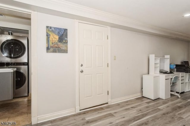 67-75 New England Ave Unit 71C, Summit City, NJ 07901 - washroom with stacked washer / drying machine, ornamental molding, baseboards, light wood finished floors, and an office area