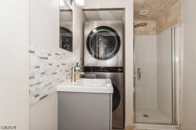 67-75 New England Ave Unit 71C, Summit City, NJ 07901 - full bathroom with stacked washing machine and dryer, a stall shower, vanity, and backsplash