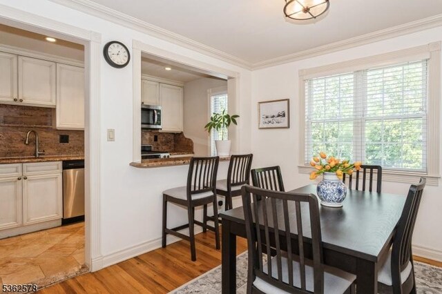 67-75 New England Ave Unit 71C, Summit City, NJ 07901 - dining room with healthy amount of natural light, ornamental molding, light wood-style floors, baseboards, and recessed lighting