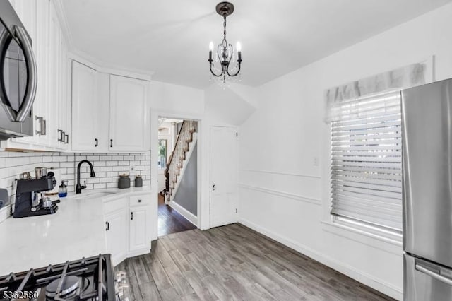 142 Westervelt Ave, North Plainfield Boro, NJ 07060 - kitchen featuring freestanding refrigerator, a sink, a chandelier, light countertops, and white cabinets