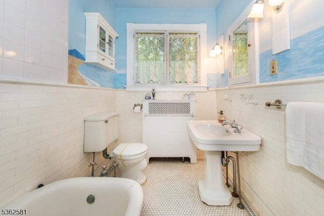 78 Broad St, Flemington Boro, NJ 08822 - bathroom with a tub, tile walls, toilet, tile patterned floors, and wainscoting