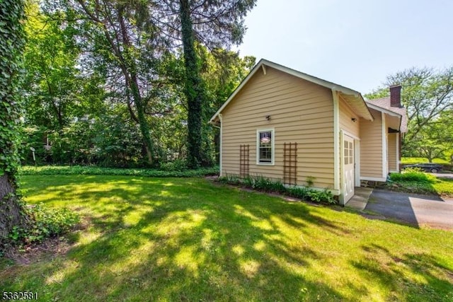 78 Broad St, Flemington Boro, NJ 08822 - view of side of property with a chimney, a yard, and a garage