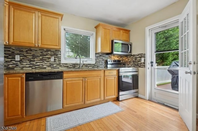 547 Logan Dr, Roxbury Twp, NJ 07850 - kitchen featuring appliances with stainless steel finishes, a sink, light wood finished floors, and stone counters
